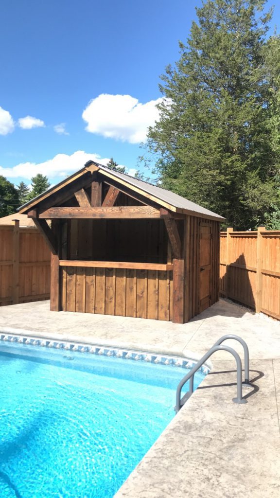 Pool bar with overhang in front of an in ground pool