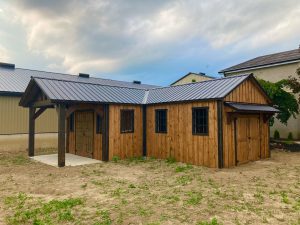 L-shaped shed with time frame porch